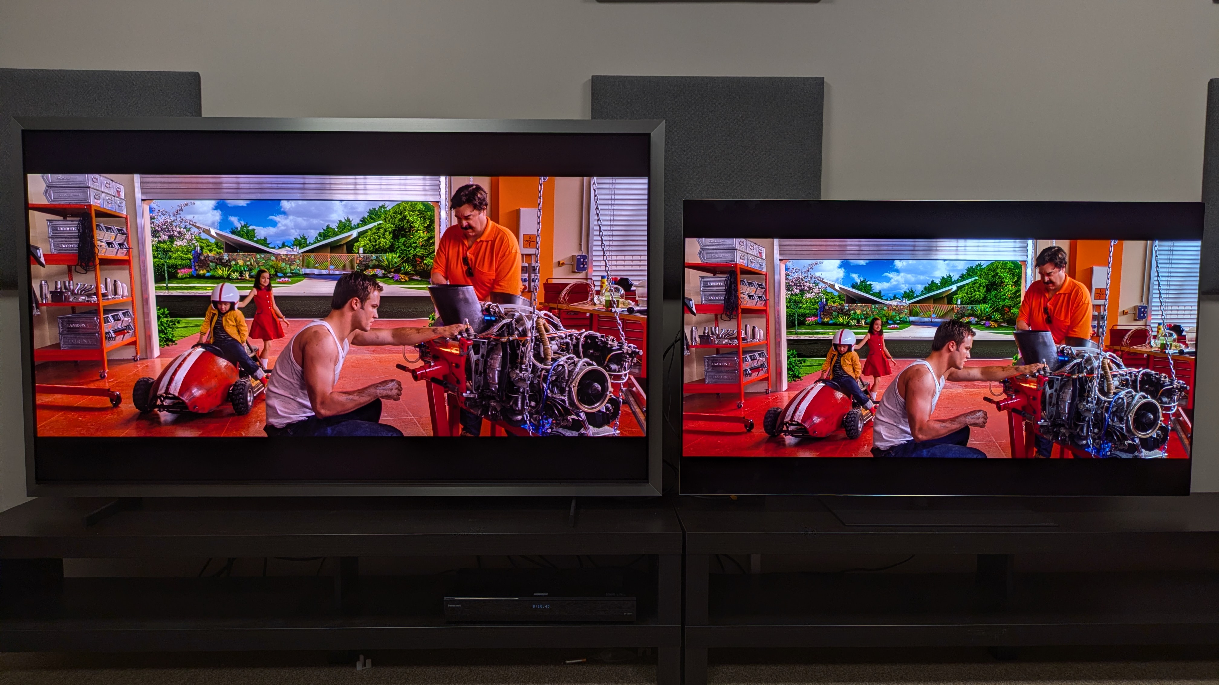 Samsung S99H (left) vs LG G6 (right) showing the Racer family in their garage from Speed Racer. The S99H makes red tones look orange in this scene, while the G6 shows a much deeper red.