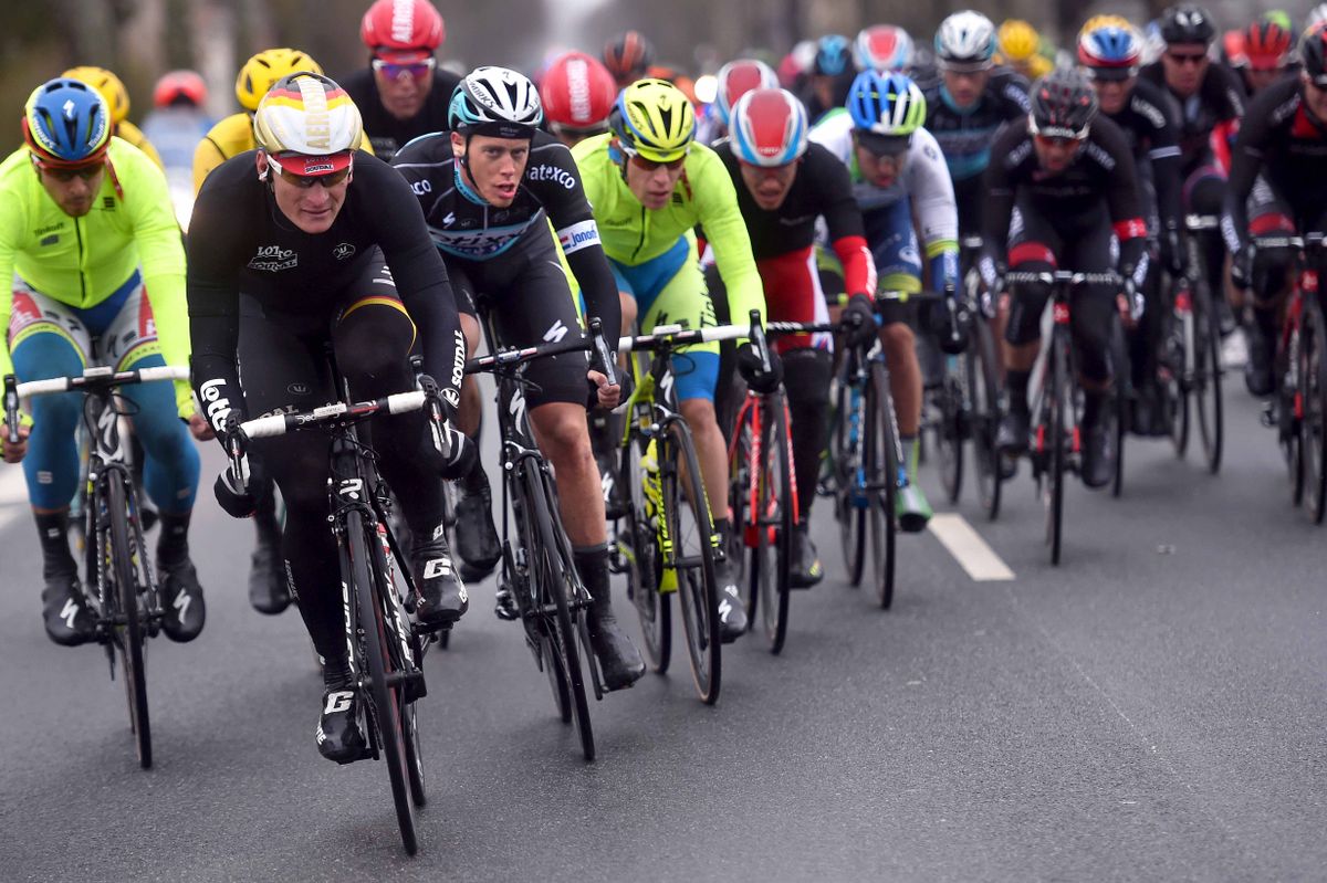 Andre Greipel (Lotto-Soudal) leads the peloton with riders scrambling to find a wheel and some protection