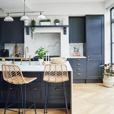 kitchen with marble island and bamboo bar stools