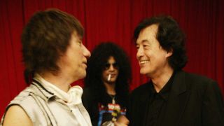 Jeff Beck and Jimmy Page photographed at an awards ceremony, with Slash in the background