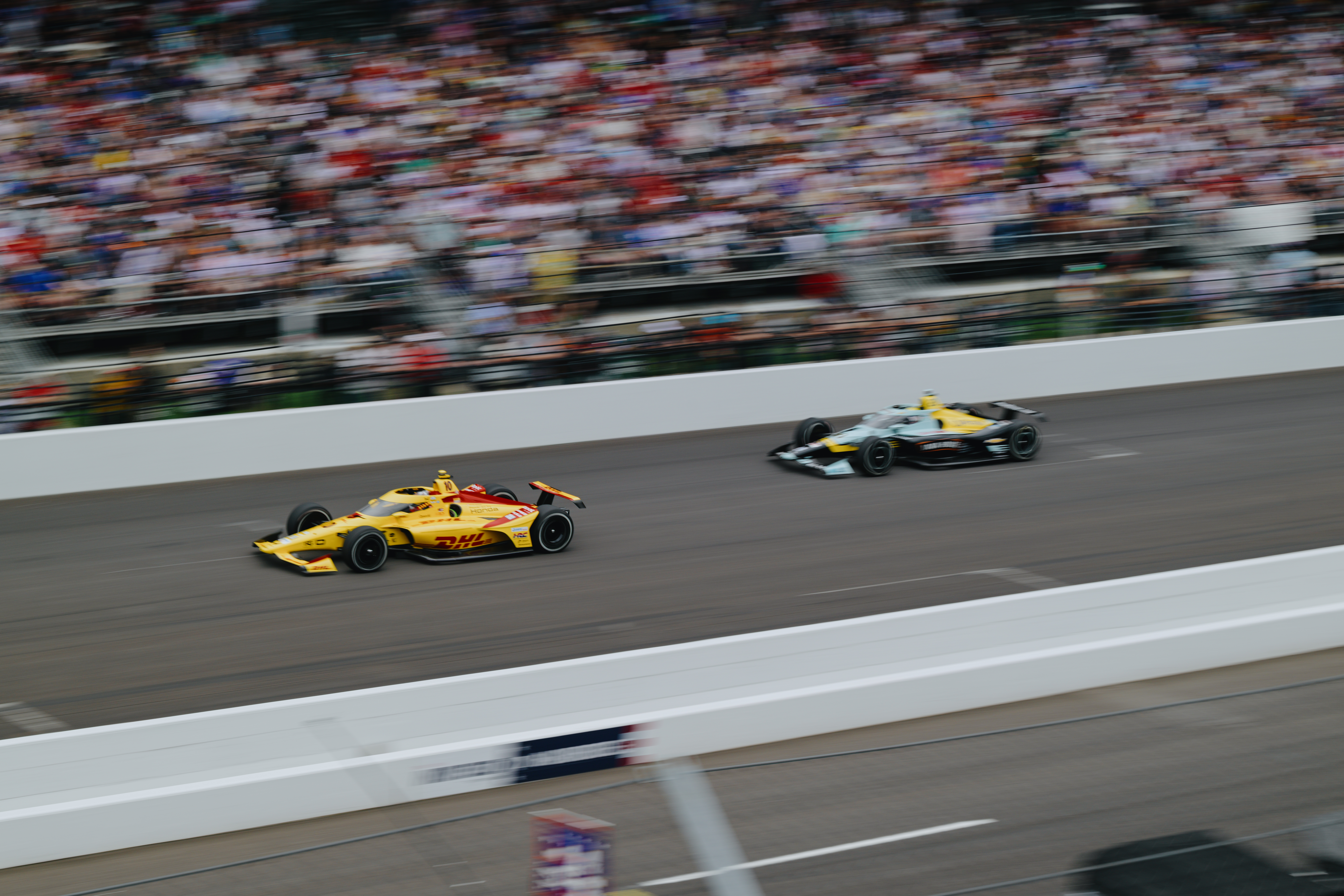 A photo of two cars racing during the 2026 Indy 500.