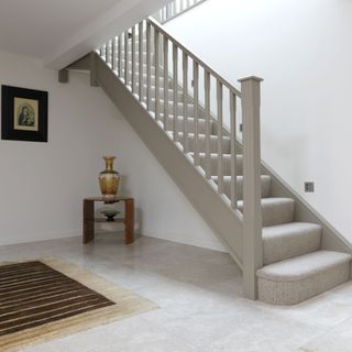 room with tiled flooring and staircase