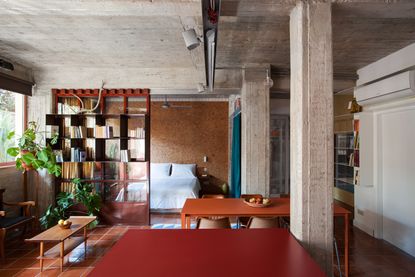 an apartment with a bedroom with a cork wall