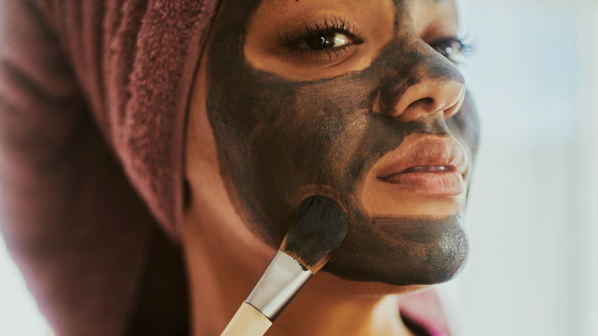 Woman applying a face mask