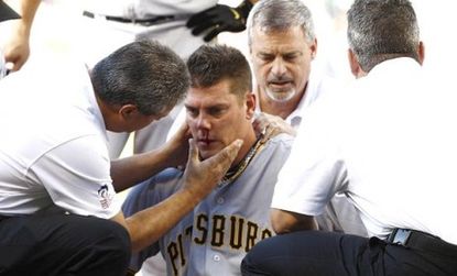 Pittsburgh Pirates pitcher Chris Jakubauskas is treated after being hit last season by a line drive; would a helmet have protected him?