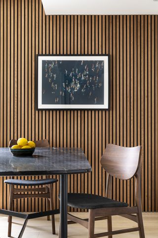 A dining room with wall paneling