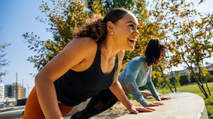 Two women doing push ups.