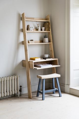 Ladder desk in a small office, with a stool and a radiator