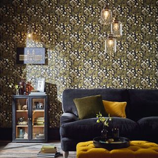 living room sofa with a matching pendant light and wall lights floral wallpaper