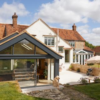 exterior of period home with glazed extension and patio area