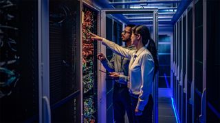 man and women undertaking maintenance in data centre