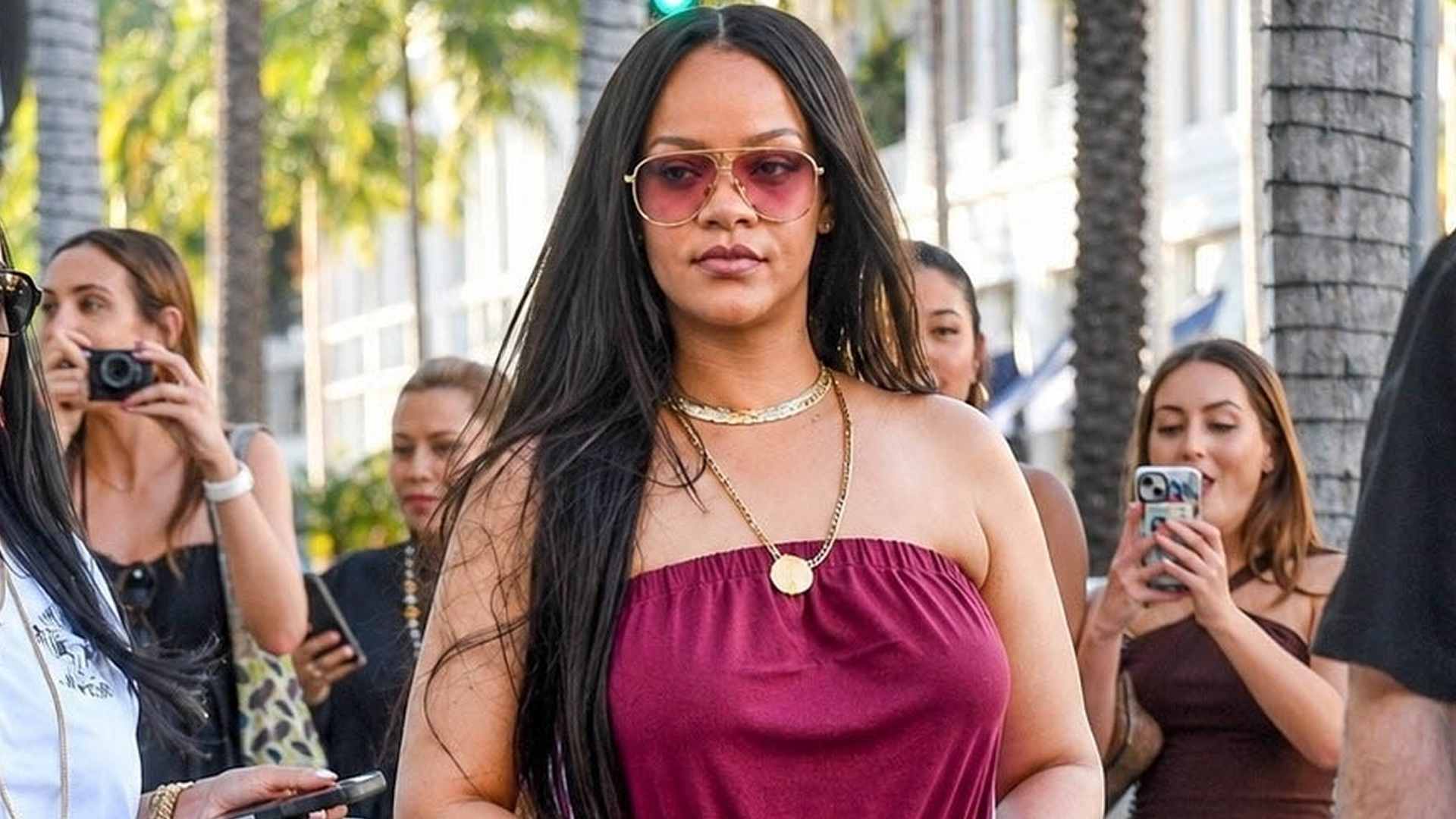 Rihanna styled a strapless sporty jumpsuit with track pant-inspired stripes up each side