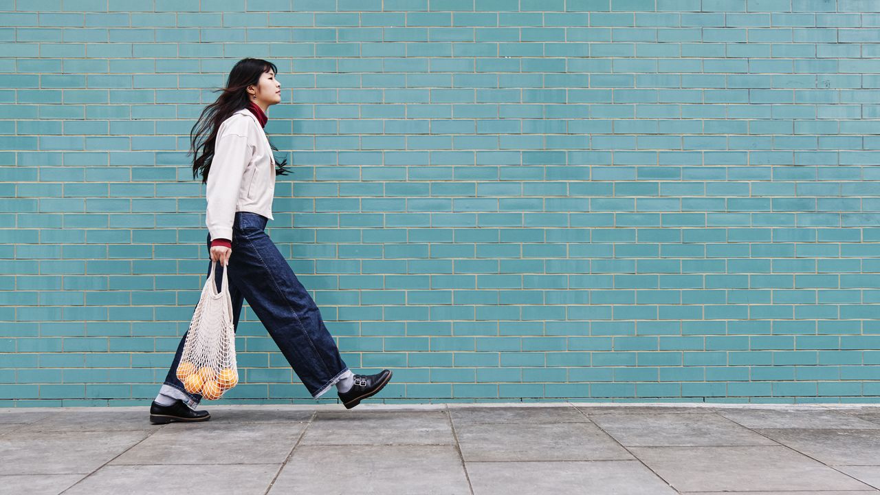 Woman walking briskly outdoors