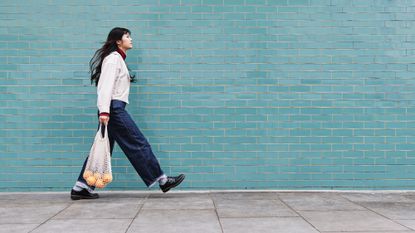 Woman walking briskly outdoors