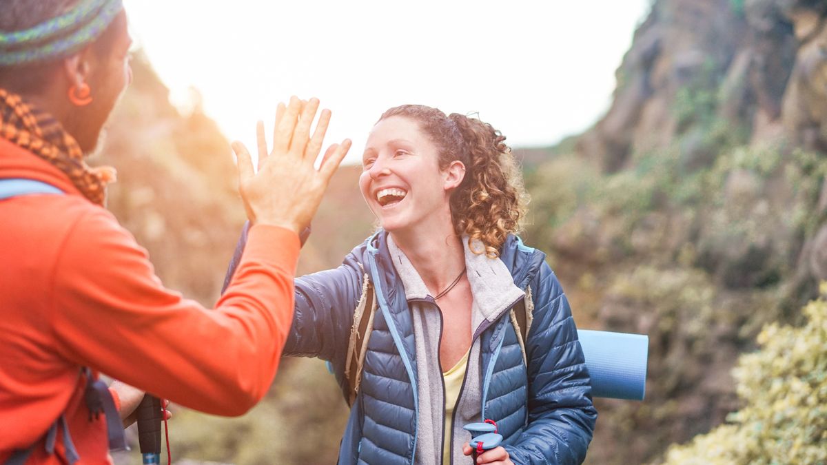 Two hikers high five