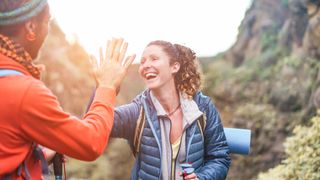 Two hikers high five