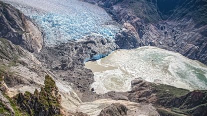 An aerial photo looking down into a valley showing the results of a landslide.