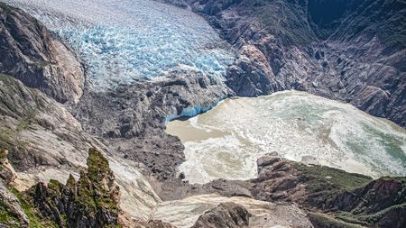 An aerial photo looking down into a valley showing the results of a landslide.