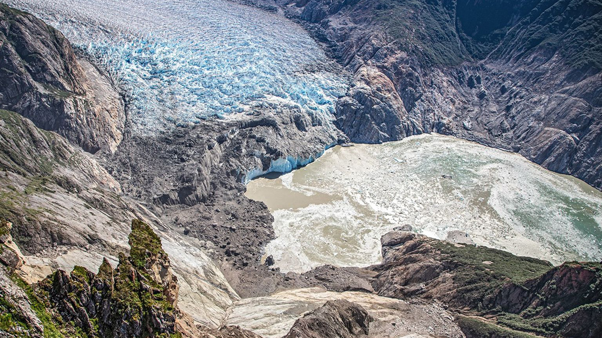 An aerial photo looking down into a valley showing the results of a landslide.