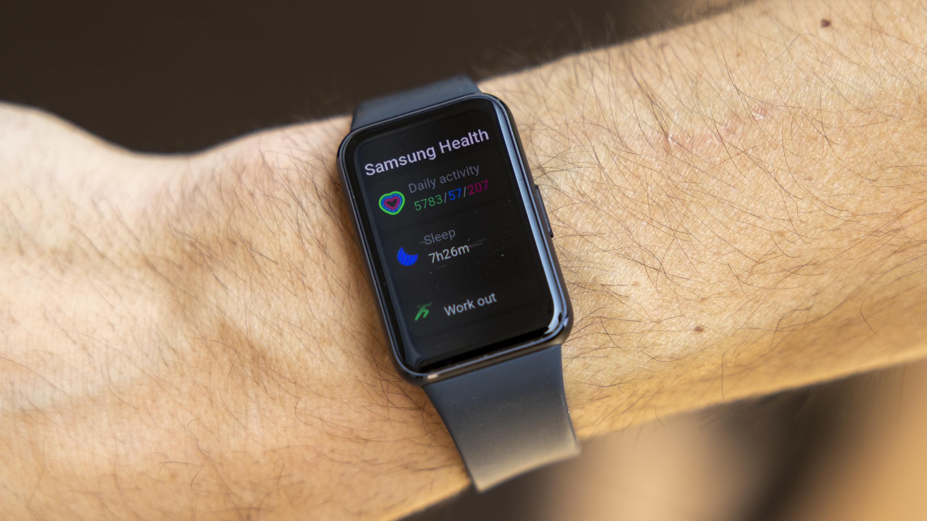 The Samsung Galaxy Fit 3 watch in grey worn on a female wrist