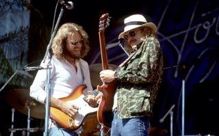 Don Felder (left) and Joe Walsh perform with the Eagles on May 30, 1977 at the Oakland-Alameda County Coliseum in Oakland, California