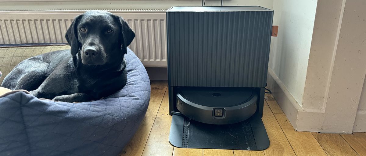 iRobot Roomba Combo 10 Max in its dock, in reviewer&#039;s home, next to a dog in its bed