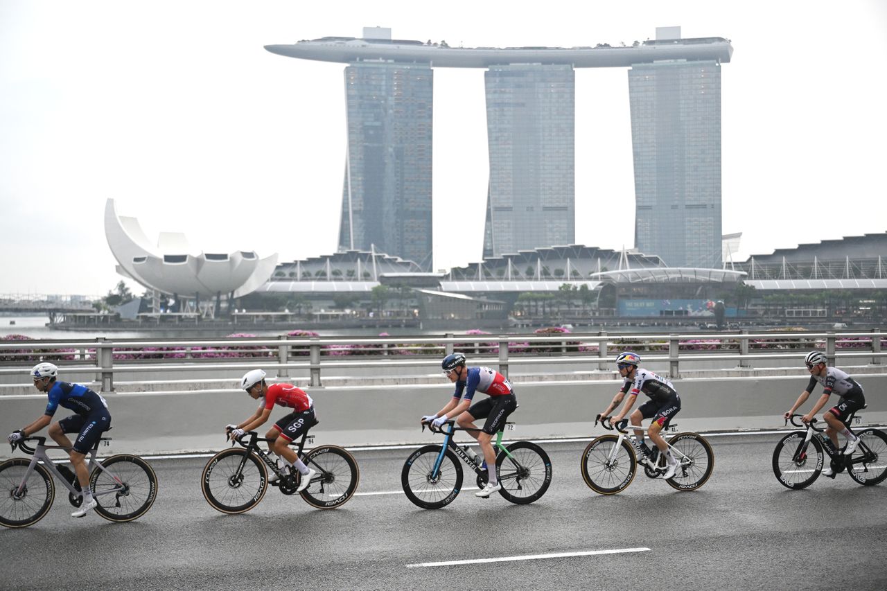SINGAPORE, SINGAPORE - NOVEMBER 02: (L-R) Dorian Godon of France and Team France, Primoz Roglic of Slovenia and Team Red Bull - BORA - Hansgrohe, 05and a general view of the peloton competing during the 4th Tour de France EFGH Singapore 2025 - Criterium Race a 57.5km one day race from Singapore to Singapore on November 02, 2025 in Singapore. (Photo by Szymon Gruchalski/Getty Images)
