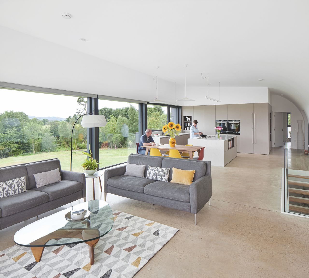 open plan living space with kitchen and large windows