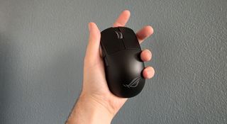 The Asus ROG Harpe Ace Mini being held in a hand