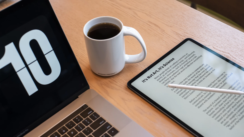 Tablet showing PDF document next to a laptop and cup of coffee