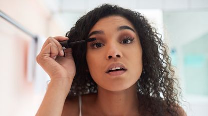 woman applying mascara