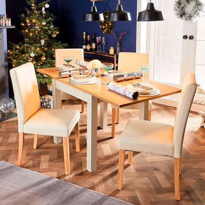 dining room with christmas tree and dining table with chairs
