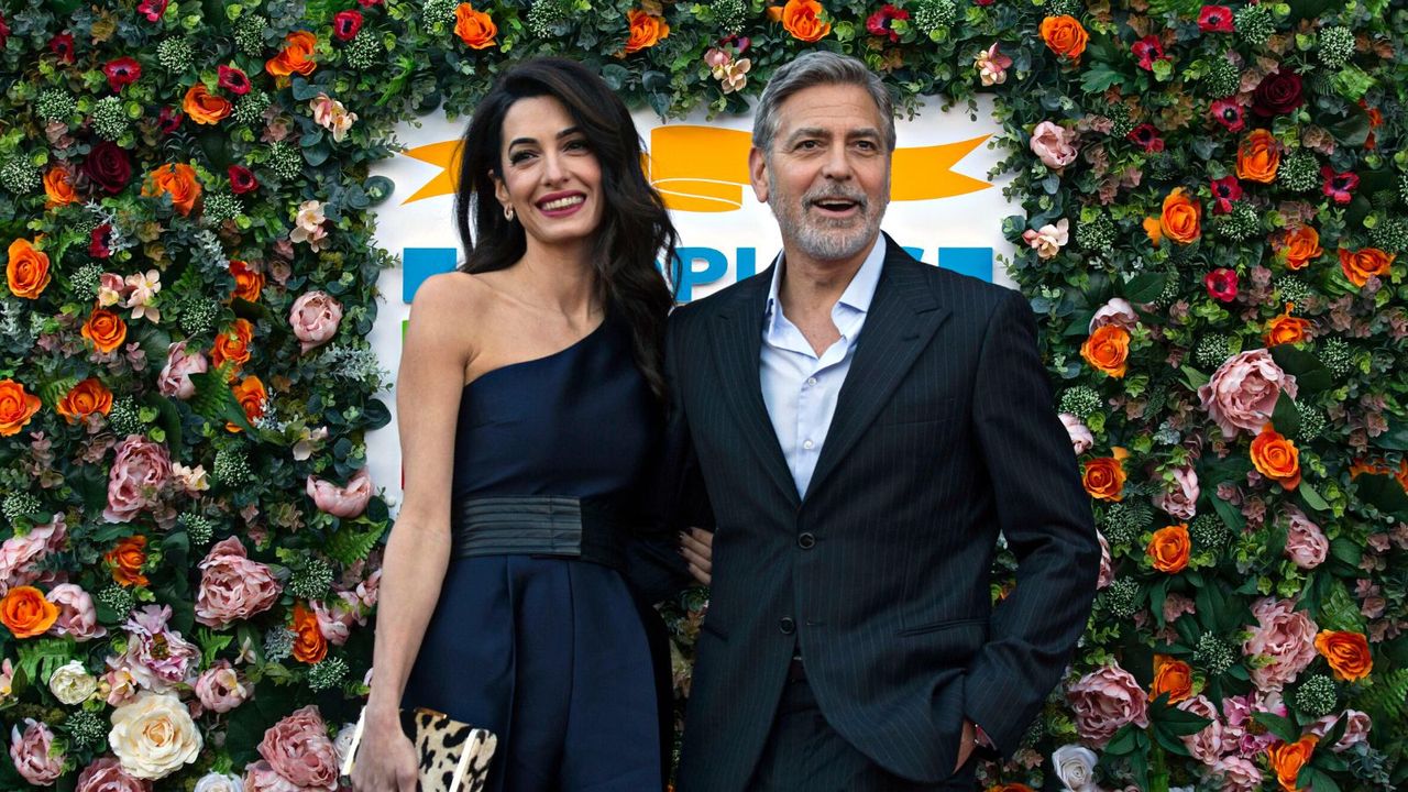 George and Amal Clooney on a red carpet