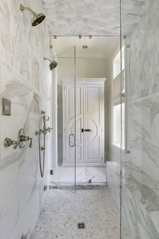 An all-white bathroom with silver hardware