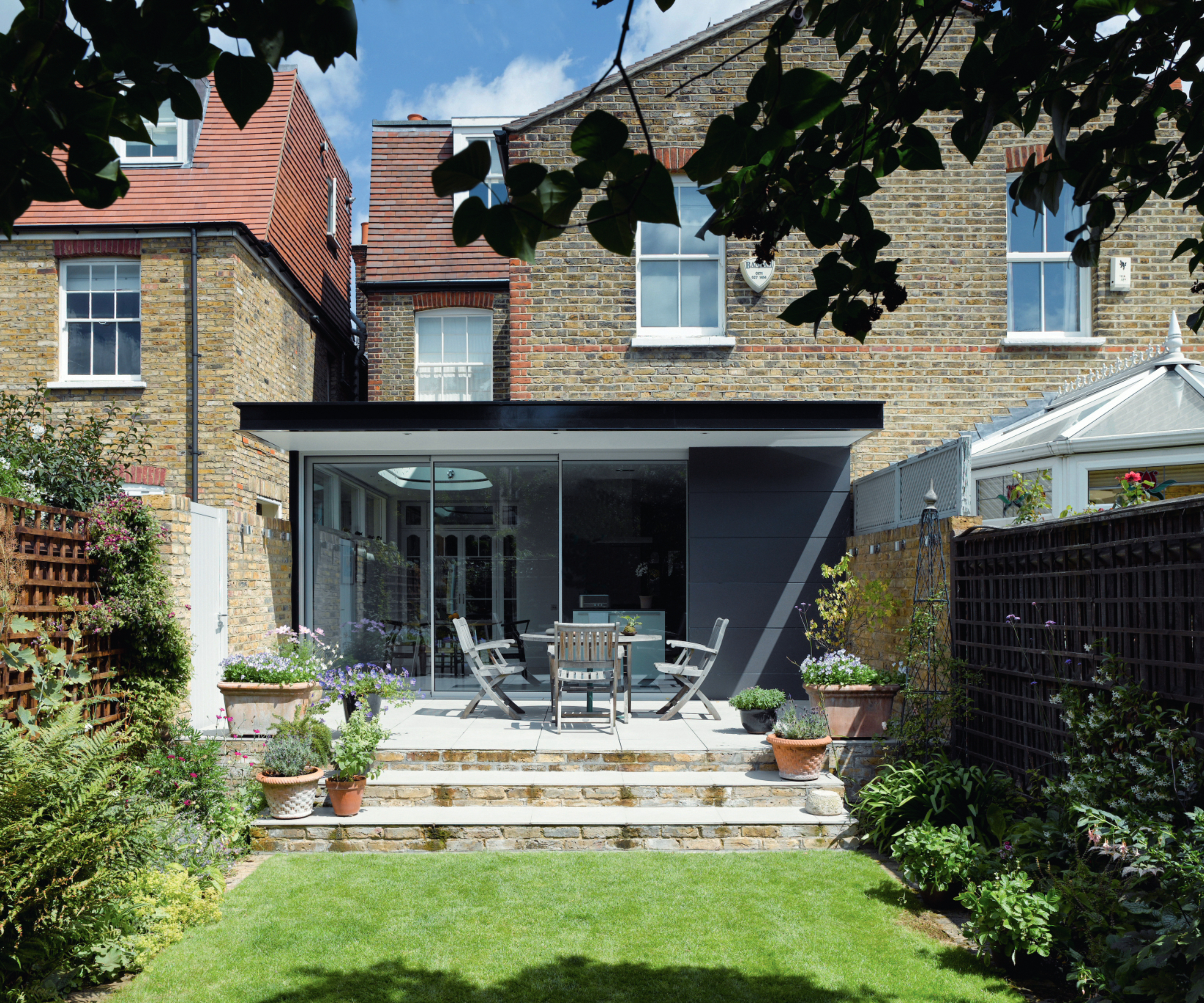 slimline sliding patio doors on a modern single storey extension on brick house