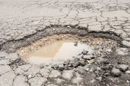 A large pothole in a road