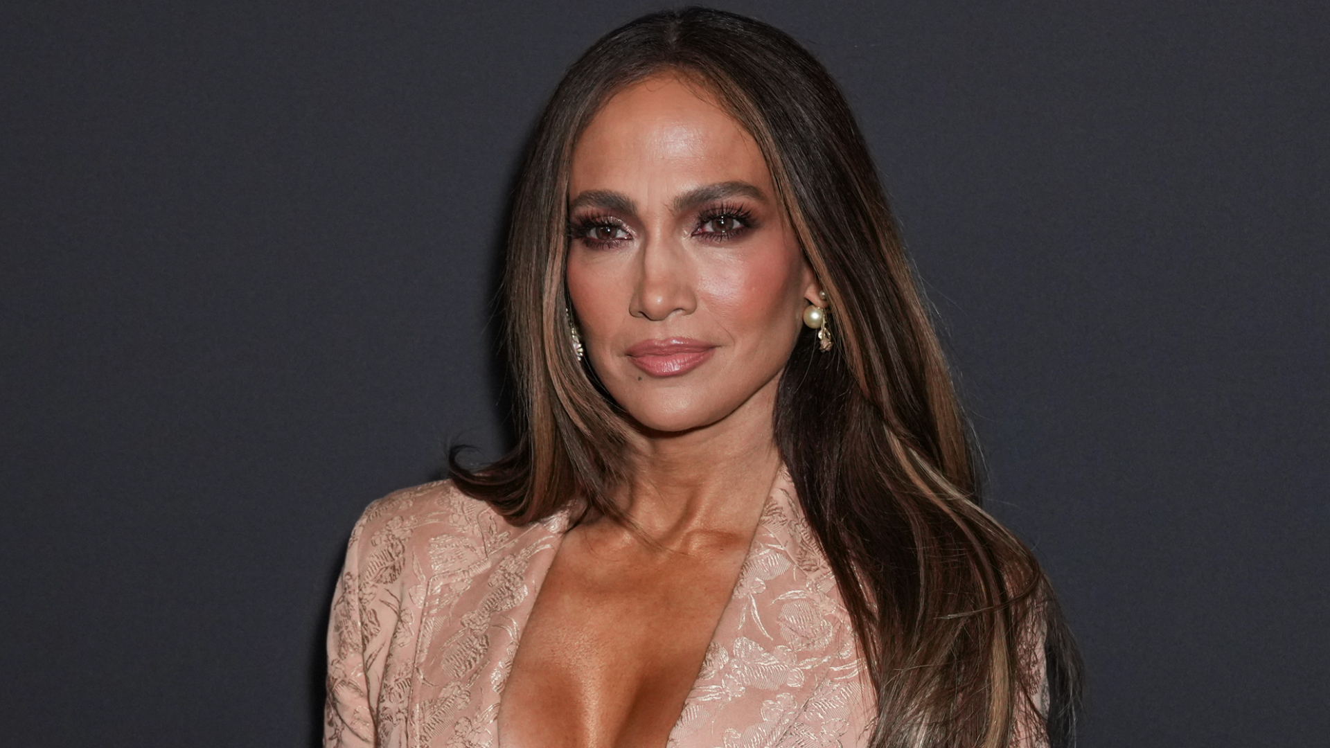 Jennifer Lopez wears a vintage Jean Paul Gaultier blazer with a spin on the lace skirt trend