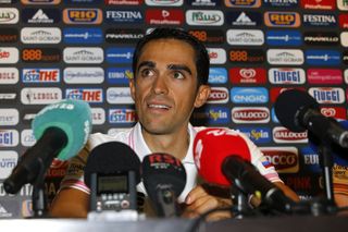 Alberto Contador surrounded by microphones