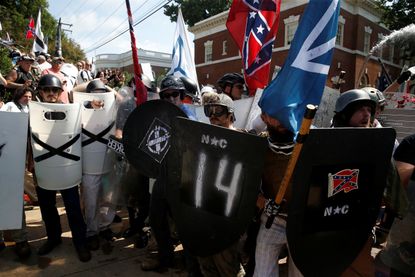 White supremacists stand behind their shields at a rally in Charlottesville, Virginia.