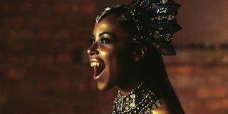 Aaliyah wearing a bejeweled headpiece and showing her fangs in 'Queen of the Damned'