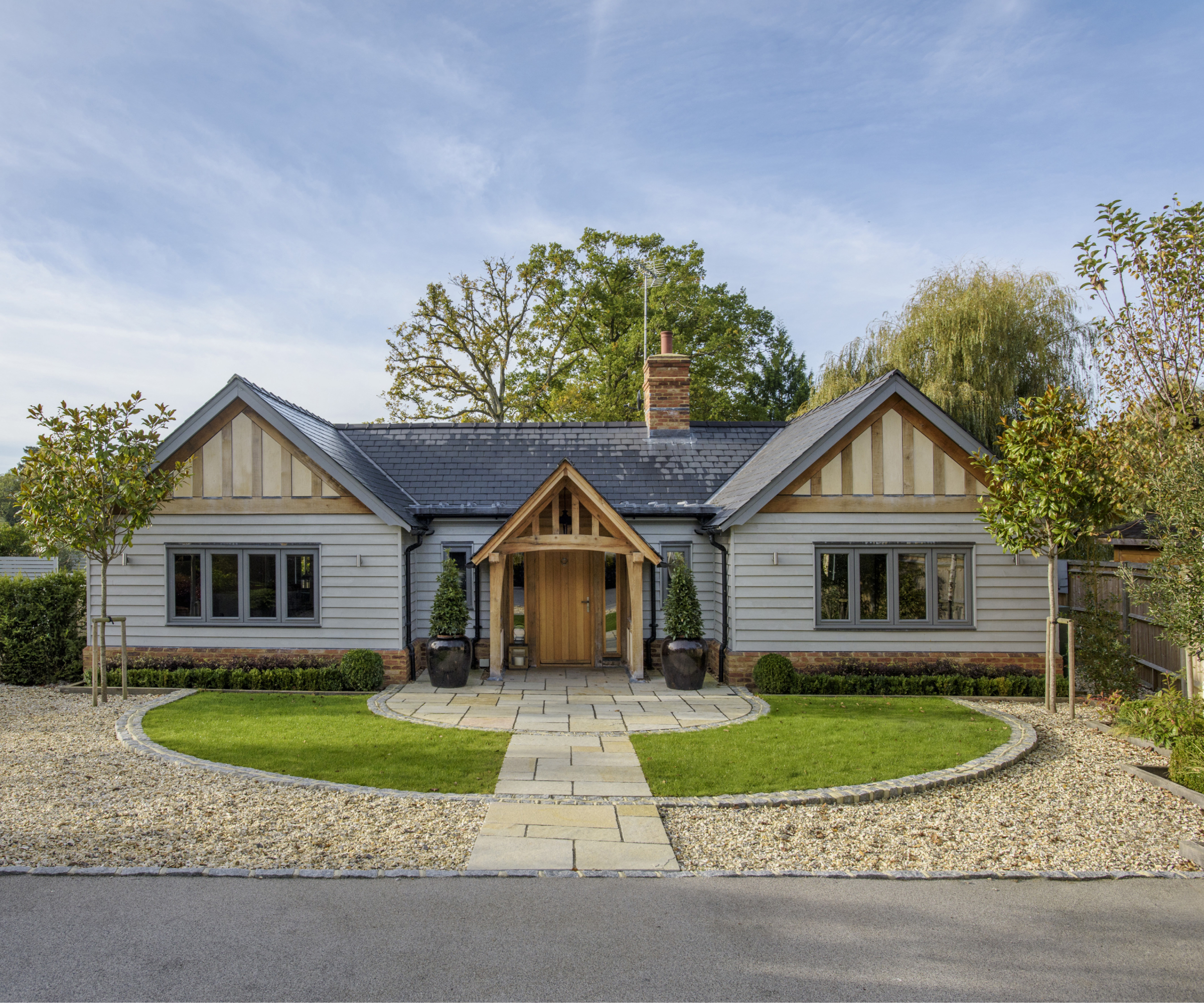 single storey timber frame home with double gable ends and porch in centre