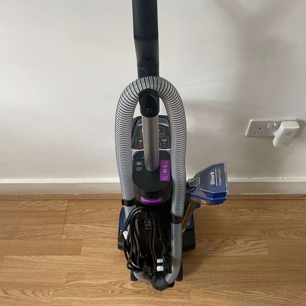 The back of the Shark CarpetXpert HairPro Pet Deep Carpet Cleaner with Spot Cleaner EX250UK with the hose and cord wrapped around the back