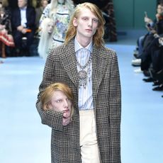 People are recreating the looks of Gucci models on the Milan runway, holding replicas of their own heads