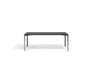 Long rectangular dining table with metal legs and slim black table top