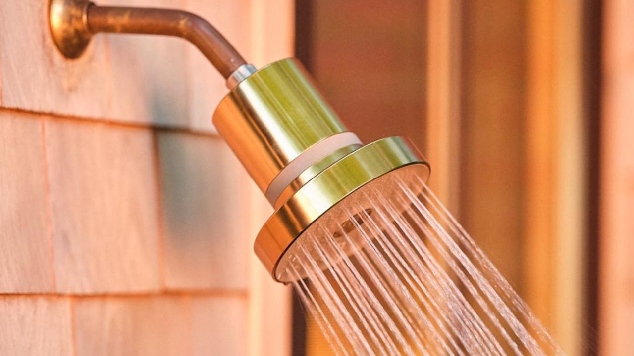 Gold shower head on wall