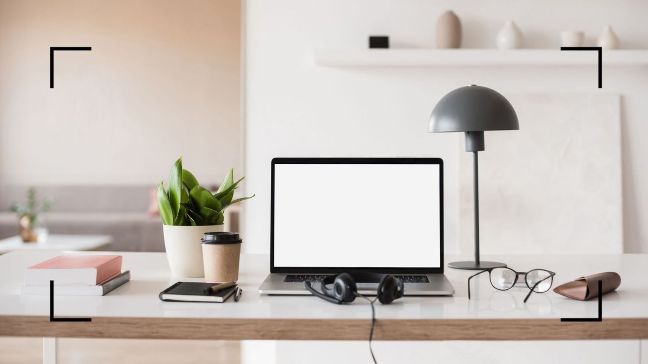 clean and minimalist desk space with laptop, to illustrate w&amp;h&#039;s working from home tips