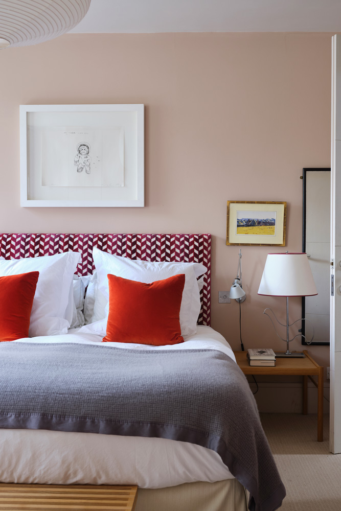 Pink grey and red bedroom with headboard