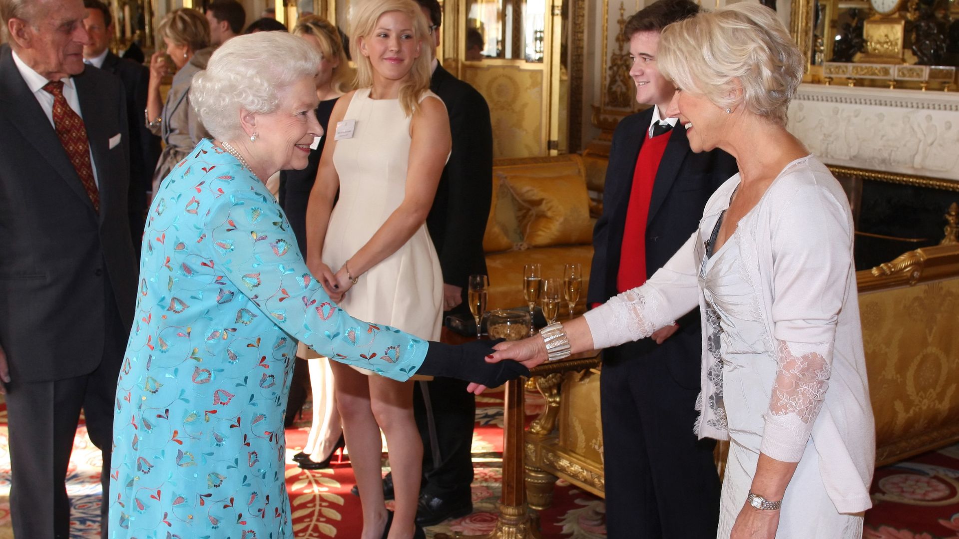 Queen Elizabeth II shaking hands with Helen Mirren