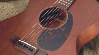 Close up of the body on a Martin 000-15M acoustic guitar lying on a sofa