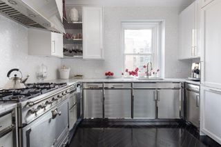 stainless steel kitchen with dark ebonized wood floor